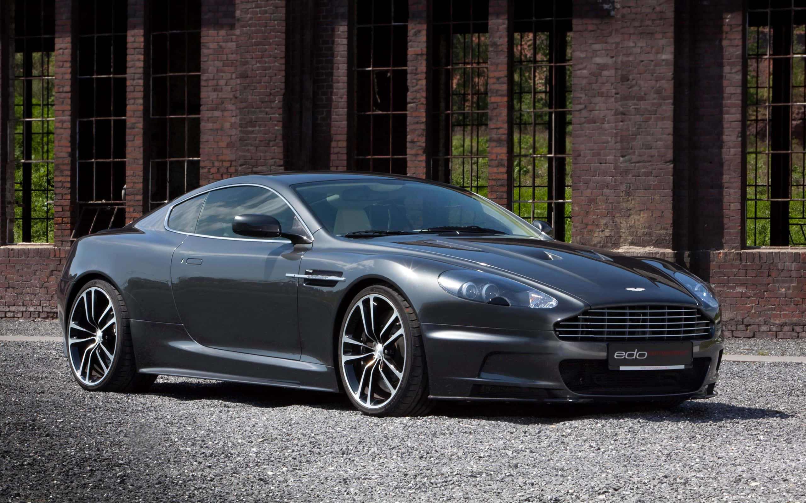 Зашемляющ сребрист Aston Martin DB9 на писта Тапет