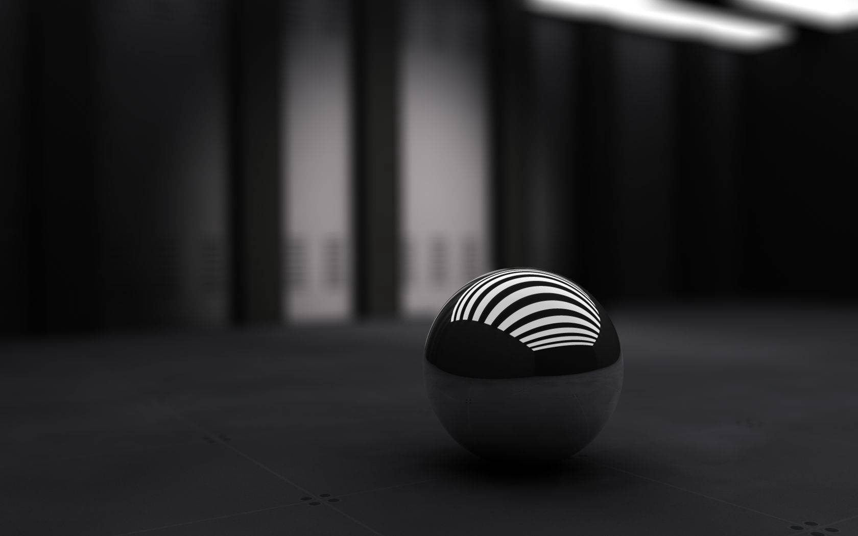 3D тапет за работен плот на малък черен кълбовиден обект.